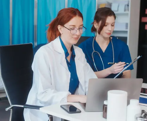 medical professionals at desk with computer
