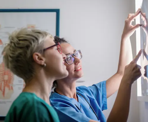 medical professionals looking at an x-ray