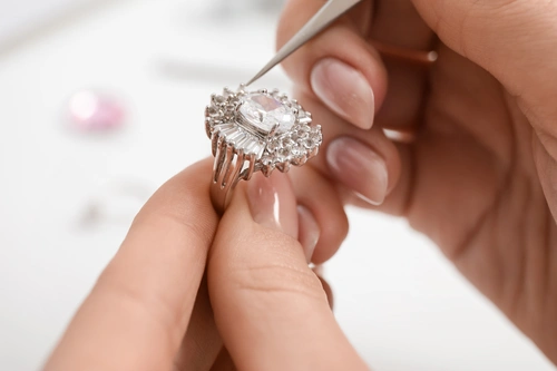 person working on a diamond ring