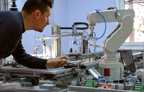 person working on a robotic arm